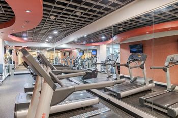 A gym with treadmills and exercise equipment